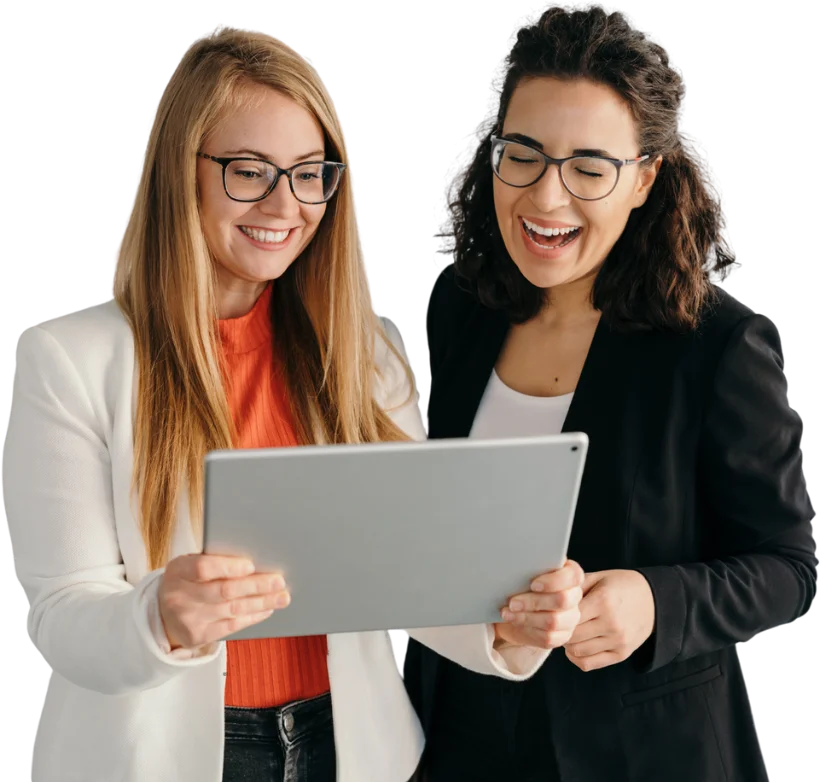 Two business women reviewing results together on a tablet